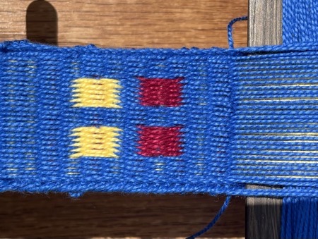 Blue band with rectangles in yellow and red.