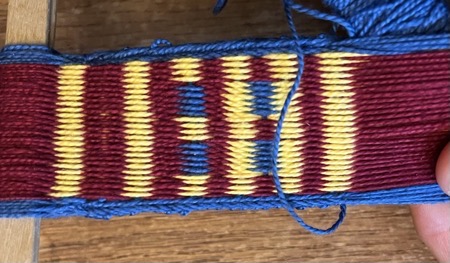 Band with red and yellow stripes and some blue patches.